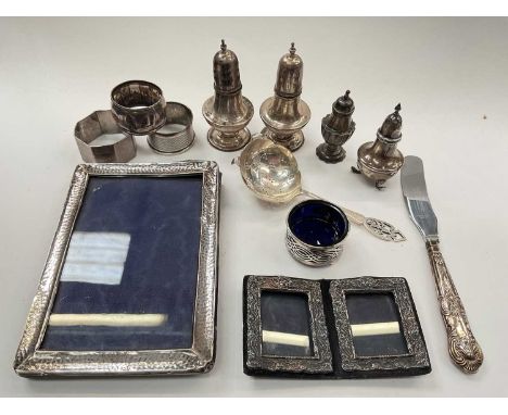Group of silver to include condiments, photograph frames, three napkin rings, sifter spoon and a silver handled knife