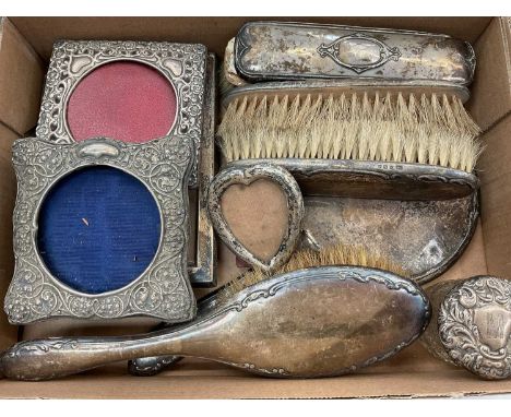 Silver backed dressing table hand mirror and brushes, various silver photograph frames, silver topped glass jar, two plated s