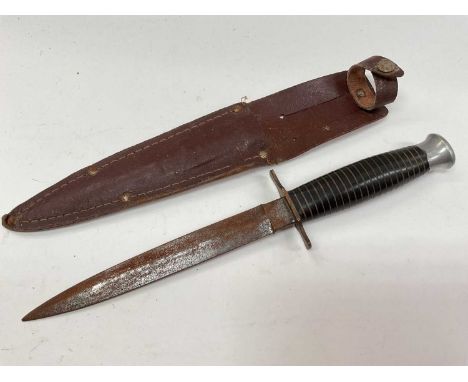 Second World War era fighting knife in leather sheath.