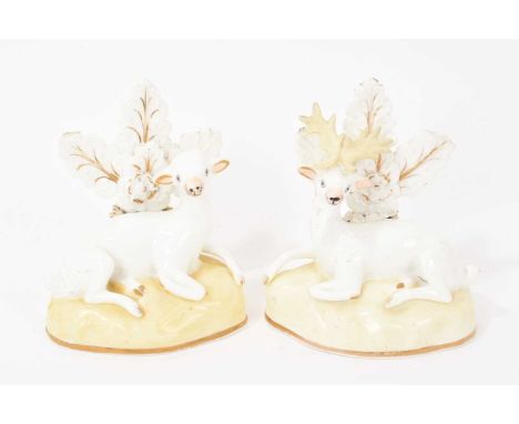 Pair of Samuel Alcock porcelain figures of a doe and stag, circa 1830, sparsely decorated, shown seated on gilt-lined bases, 
