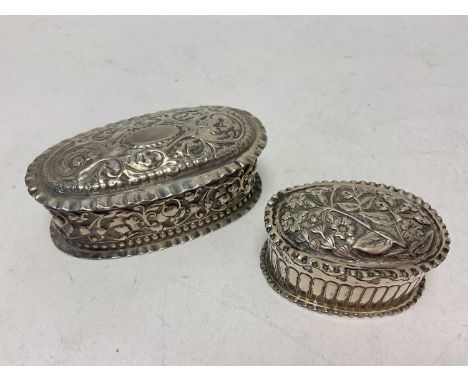 Two Victorian silver oval trinket boxes with embossed floral scroll decoration, 9.5cm wide and 6.5cm wideTotal weight 111.9 g
