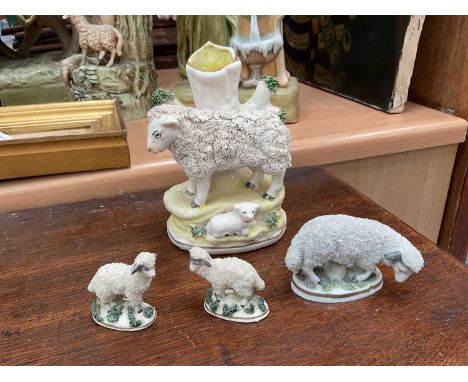 A late Staffordshire sheep and lamb spill vase, and three small Continental porcelain sheep