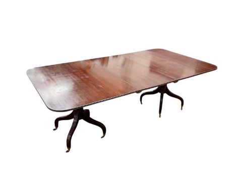 Regency-style twin pedestal dining table with extra leaf, with turned and bulbous column supports on four splayed receded leg