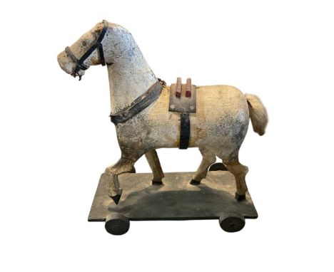 Folk art child's model of a horse, on wheel base, 20cm high