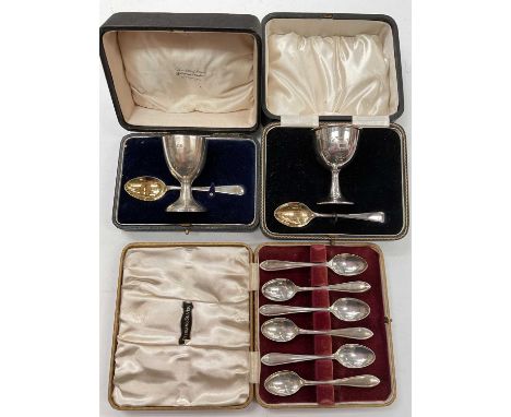 Two cased silver eggs cups and spoons, together with a set of six silver coffee spoons in fitted case