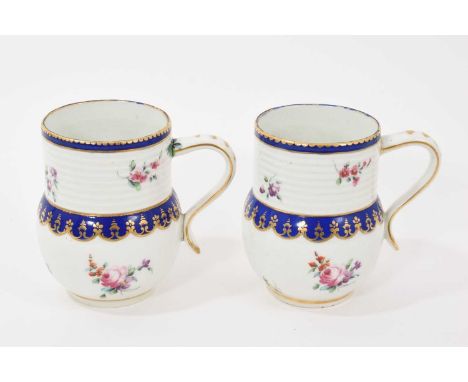 Pair of Chelsea Derby baluster shaped mugs, circa 1775, the top section with moulded banding, polychrome painted with floral 