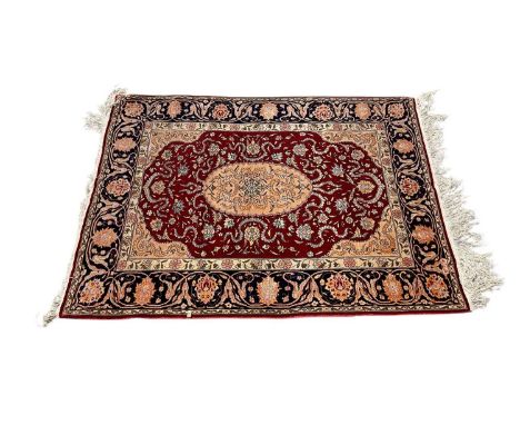 Good quality silk rug on red and blue ground, 117cm x 91cm