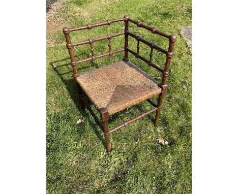 Arts and crafts oak corner chain in the manner of Liberty's with caned seat and turned lattice backOne or two old worm holes,