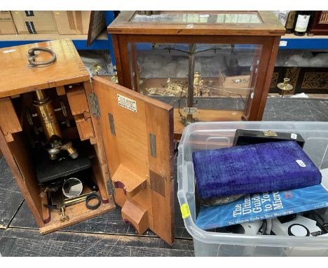 Two microscopes, a chemist's balance scales and an aneroid barometer in serpentine frame
