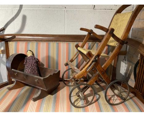 19th century miniature model of a cot with 19th century peg doll and a Victorian push chair