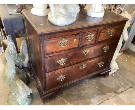 A George II elm chest of drawers, the moulded rectangular top above three short and three long drawers on ogee feet, 98cm wid