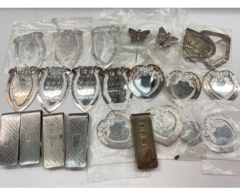 Silver money clip together with other plated money clips and bookmarks