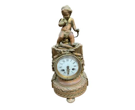 19th century French gilt metal figural mantel clock, with Cupid surmount and of fluted column form having white enamel dial, 