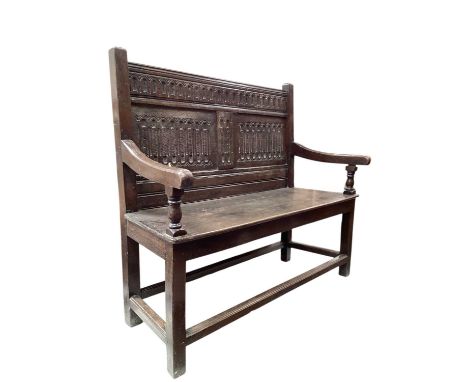 Antique carved oak hall bench, 120cm wide, 40.5cm deep, 104.5cm highBoth arms are loose, small loss on the seat otherwise goo