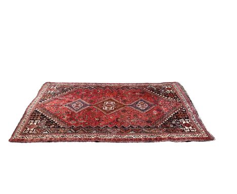 Eastern rug with three central medallions on red, blue and cream ground, 258cm x 168cm