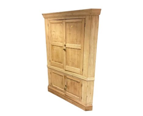 Antique pine corner cupboard with shaped shelves enclosed by four panelled doors, 140cm wide, 192.5cm high