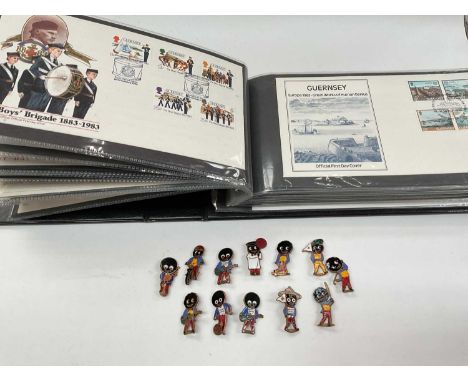 Album of Guernsey First Day Cover and a collection of enamelled Golly badges
