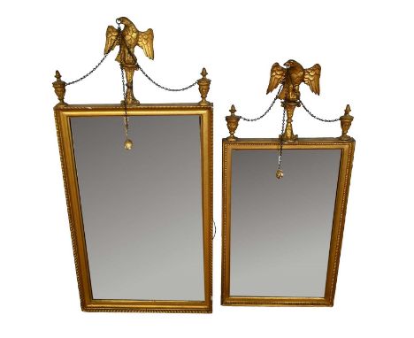 Two similar George III gilt pier mirrors, each with rectangular bevelled plate, with urn and eagle surmount, hung with chains