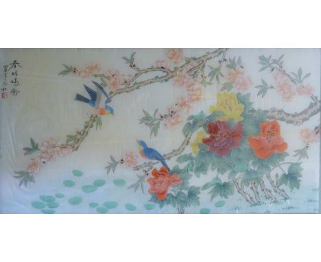 A Chinese painting on silk depicting birds among foliage, framed and glazed. 54 x 105 cm.