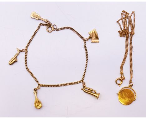 A 9 ct gold 'Good Luck' spinning pendant on a 9 ct gold chain and a gold-plated charm bracelet with musical instrument charms