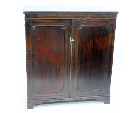 A 19TH CENTURY MAHOGANY LINEN PRESS the two panelled doors opening to reveal four sliding linen drawers and all standing on b