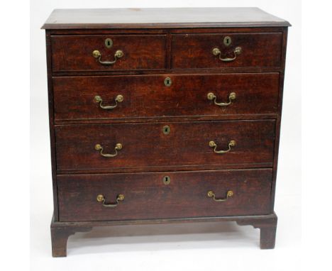 A 19TH CENTURY OAK CHEST OF TWO SHORT AND THREE LONG DRAWERS with brass swan neck handles and bracket feet, 102cm wide