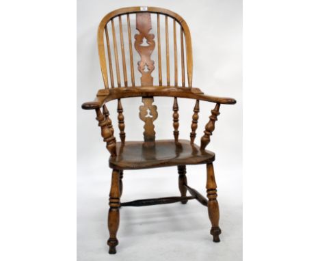 A 19TH CENTURY ASH AND ELM THAMES VALLEY HIGH BACKED WINDSOR SMOKERS BOW ARMCHAIR with pierced vase shaped splat back and tur