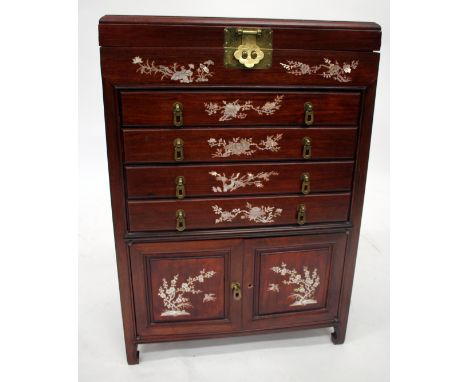 AN ORIENTAL HARDWOOD CANTEEN CABINET with mother of pearl prunus decoration, the cabinet with lifting lid to the top above fo