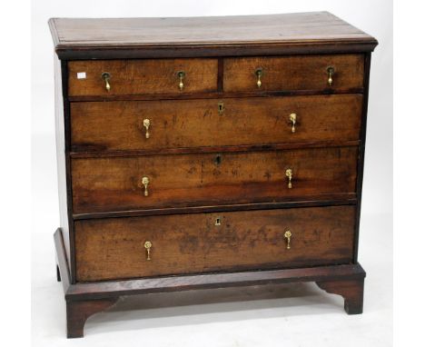 AN ANTIQUE OAK CHEST OF TWO SHORT AND THREE LONG DRAWERS with brass drop handles and standing on bracket feet, 94.5cm wide x 