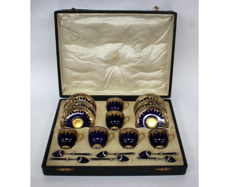 AN EARLY 20TH CENTURY ROYAL WORCESTER COFFEE SERVICE in cobalt blue with gilded decoration and having six blue enamelled coff