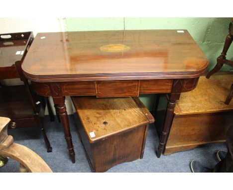 A LATE GEORGE III MAHOGANY AND STRING INLAID FOLD OVER TOP CARD TABLE of D shaped outline, the top inlaid with an oval shell 