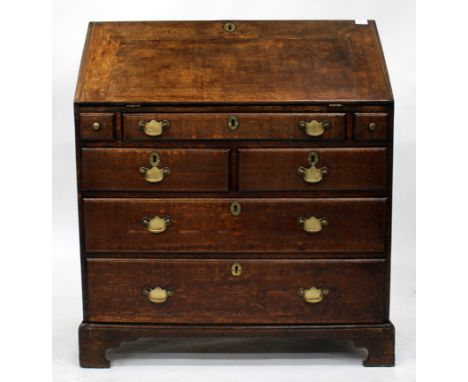 A 19TH CENTURY OAK BUREAU, having five drawers, brass handles and bracket feet, 91cm wide 