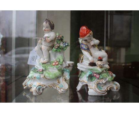 A PAIR OF BOW PORCELAIN FIGURES of putti, one resting among flowers, the other by a small brazier, the largest 19.5cm high (2