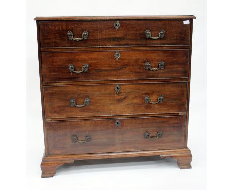AN EARLY 19TH CENTURY MAHOGANY CHEST OF FOUR LONG DRAWERS with crossbanded top and standing on ogee bracket feet, 100cm wide 