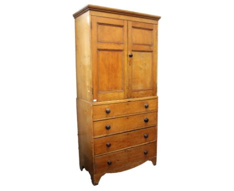 A VICTORIAN PINE LINEN PRESS with two panelled doors above four long drawers with turned knob handles and bracket feet, 106cm