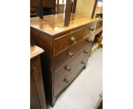 AN EARLY 19TH CENTURY MAHOGANY CHEST OF TWO SHORT AND THREE LONG DRAWERS with brass knob handles and splayed bracket feet, 10