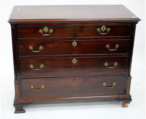 A GEORGE III MAHOGANY CHEST, the top with a moulded edge above two short and three graduated long drawers flanked by turned p
