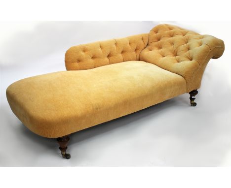 A VICTORIAN CHAISE LOUNGUE,  with later button back upholstery, turned mahogany legs and brass casters, one leg stamped with 