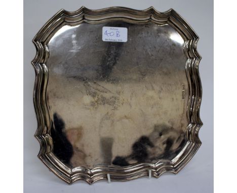 A SILVER SQUARE SALVER with serpentine pie crust edge, marks for Sheffield and makers of Walker & Hall, 26cm wide 
