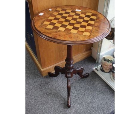 A VICTORIAN WALNUT AND TRIPOD GAMES TABLE, a circular top with a satinwood and rosewood inlaid chess board, the top 52cm diam