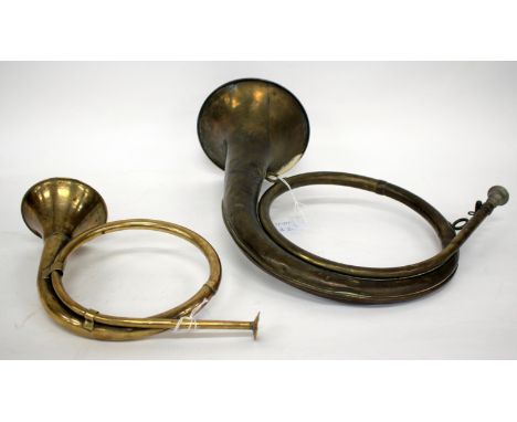 A 19TH CENTURY FRENCH BRASS HUNTING HORN 41cm wide, a further antique brass hunting horn (2)