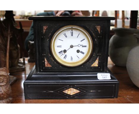 A VICTORIAN BLACK SLATE MANTEL CLOCK, the circular white enamel dial with Roman numerals and striking mechanism, 23cm high