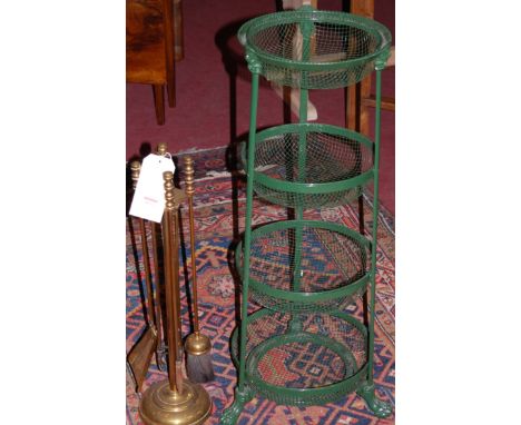A modern gilt metal four piece fire tool suite on stand, together with a green painted metal four tier stand in the Regency s