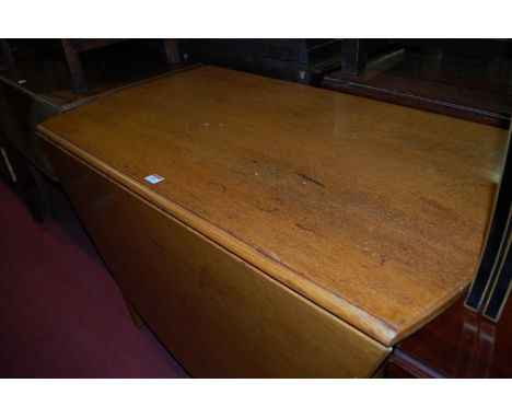 A circa 1900 light oak drop leaf dining table having gateleg action