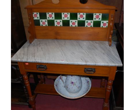 An Edwardian satin walnut white variegated marble topped and tile inset single drawer washstand, with en-suite ceramic jug an
