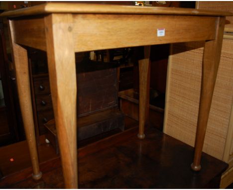 An early 20th century joined light oak rectangular occasional table 