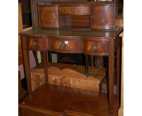 A reproduction mahogany serpentine front three drawer writing table having raised superstructure Condition Report / Extra Inf