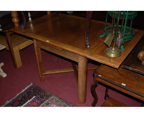 A 1930s light oak drawer leaf dining table