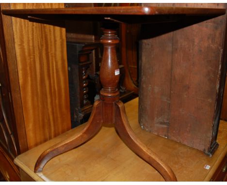 An early 19th century mahogany round cornered tilt top pedestal tripod table