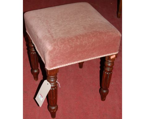A mahogany and pink floral upholstered square section dressing stool, raised on turned and reeded supports 